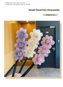 Detailed view of floral hair bun makers in purple, cream, and pink soft organza fabric