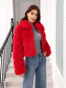 Detail of red faux fur jacket featuring thick texture and large collar on model