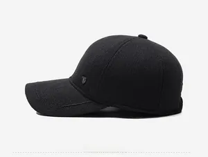 Detail of black winter baseball cap with metal shield badge and embossed sport lettering