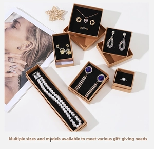 Assorted jewelry pieces in kraft paper gift boxes with pearls and blue gemstones