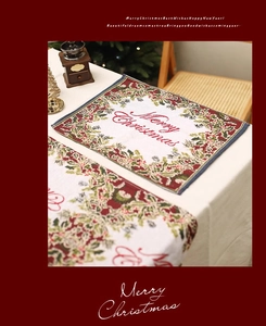 Close-up of Christmas table runner with Merry Christmas text and holly berry prints
