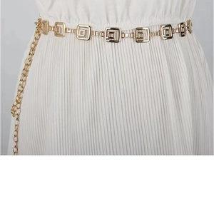 Detailed shot of golden geometric square metal waist chain with elegant tassel fringe
