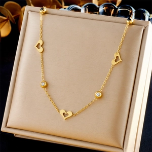 Elegant gold stainless steel necklace featuring hollow hearts and sparkling crystal charms