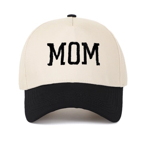 Close-up of MOM embroidery on beige and black two-tone cotton trucker baseball cap