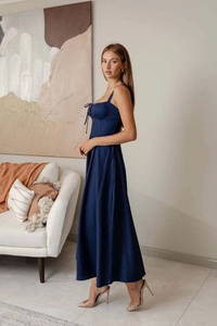 Detail of dark blue denim midi dress showing tie-front bustier and open back design