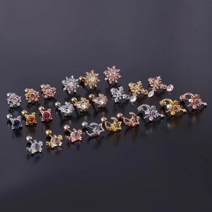 Macro shot of stainless steel stud earrings with star, moon and colorful zircon stone