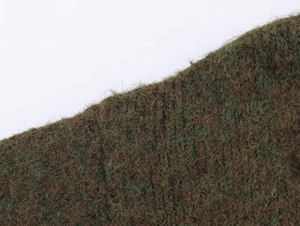 Macro shot of dark jacquard knit cardigan showing green and red fiber texture