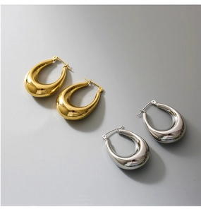 Polished gold and silver teardrop hoop earrings showing high shine and click-top closure