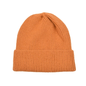 Detailed close-up of mustard yellow knitted beanie showing soft ribbed texture and cuff
