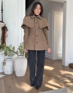 Detail of camel wool cape coat featuring single-breasted buttons and stylish shawl collar
