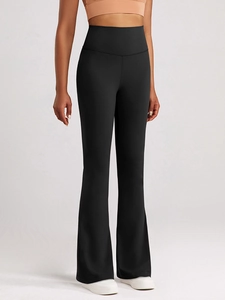 Detailed view of high-waisted black flared yoga pants with sculpting tummy control fit