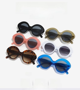 Flat lay of oval sunglasses in black, pink, tortoiseshell, green, white and blue