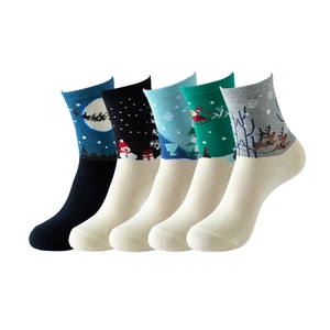 Detail view of five pairs of colorful Christmas theme cotton socks with holiday patterns