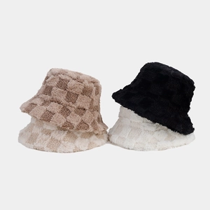 Detail of plush checkered bucket hats in khaki and beige for winter warmth