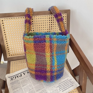 Detail showing the colorful faux shearling texture of the checkerboard bucket bag