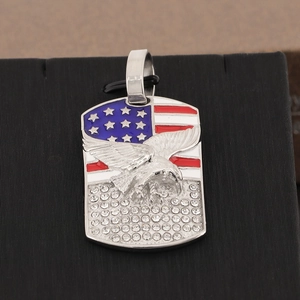 Macro detail of iced-out eagle pendant with American flag enamel and square crystals