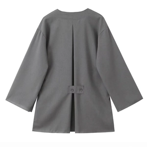 Detail of grey linen-style kimono jacket back with pleated texture and dual button accents