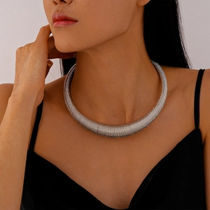 Detail showing metallic spiral textured choker necklace on female model neck