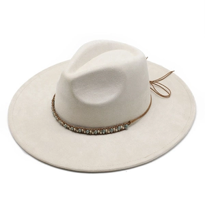 Close-up of beige suede jazz hat with ethnic beaded band and decorative rear bow detail