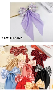 Detail of multi-color plaid and silk bow hair clips with silver metal spring fastener