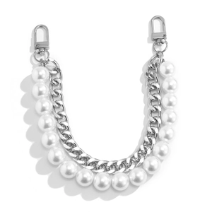 Close-up of double-layer bag chain with white faux pearls and silver cuban links