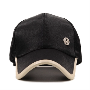 Detailed close-up of glossy satin baseball cap with M logo and contrast brim edge