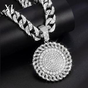 Close-up of hip-hop silver spinning money pendant on a chunky iced-out Cuban chain