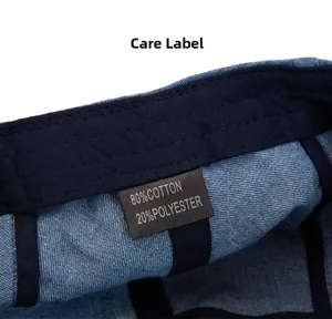 Detail of internal care label on denim beret showing 80% cotton and 20% polyester material