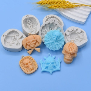 Halloween skull silicone molds for DIY resin casting and cake baking on blue background