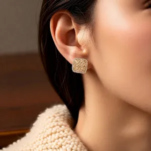 French style rhombus zircon stud earrings in gold finish worn by a model