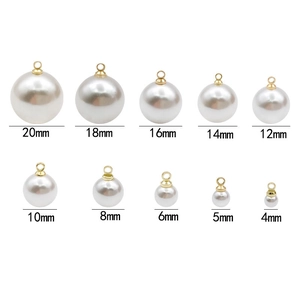 Faux pearl round pendants in sizes 4mm to 20mm with gold metal caps on white background