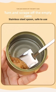 Stainless steel flat head spoon scraping the inner wall of a round pet food can