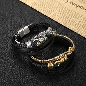 Close-up of multilayer braided leather bracelets with gold and silver magnetic clasps