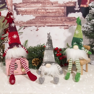 Three sitting Christmas gnomes with glowing lights on a cozy winter cabin background
