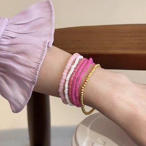 Detail shot of multi-layer Bohemian beaded bracelet set on wrist in vibrant colors