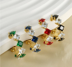 Macro shot of 18K gold plated C-hoop earrings featuring square cut multi-color zircons