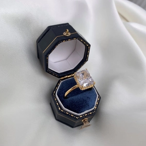 Macro shot of rectangular-cut diamond ring in a vintage navy velvet gift box