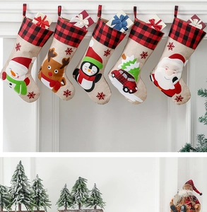 Set of five hanging Christmas stockings featuring reindeer and snowman on fireplace