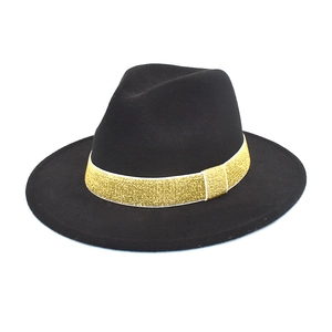 Close-up of black wool felt fedora featuring a decorative gold glitter band for winter