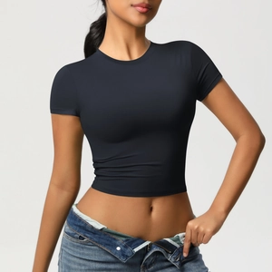 Close-up of black tight-fit short sleeve crop top paired with stylish blue jeans