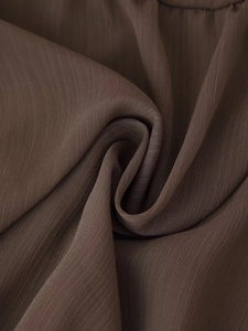 Detailed macro view showing the deep brown fabric texture and woven fiber patterns
