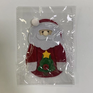 Detail of Santa Claus cutlery holder with felt star and Christmas tree ornaments