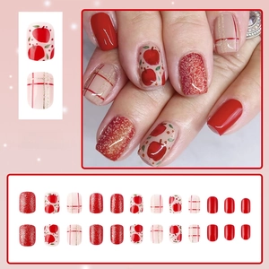 Short square red Christmas press-on nails with apple patterns and glitter accents