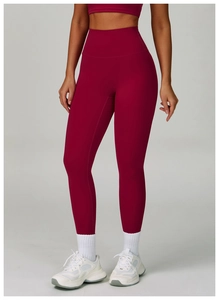 Detail of high-waist yoga pants in deep burgundy with seamless tummy control design