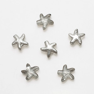 Detailed view of silver starfish metal pendants with textured surface for DIY jewelry