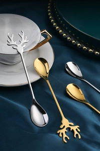 Close-up of moose antler handle coffee spoons in gold and silver stainless steel