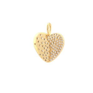 Macro detail of a heart-shaped gold pendant with sparkling pavé white zircon stones