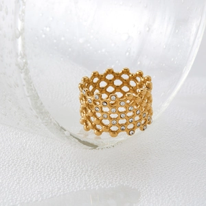 Golden honeycomb hollow ring with inlaid crystals on a fresh water droplet background
