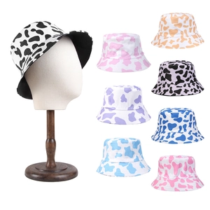 Reversible cow print bucket hats in multiple colors for casual sun protection style
