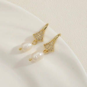 Detail of 14K gold plated earrings with pave cubic zirconia and baroque freshwater pearls